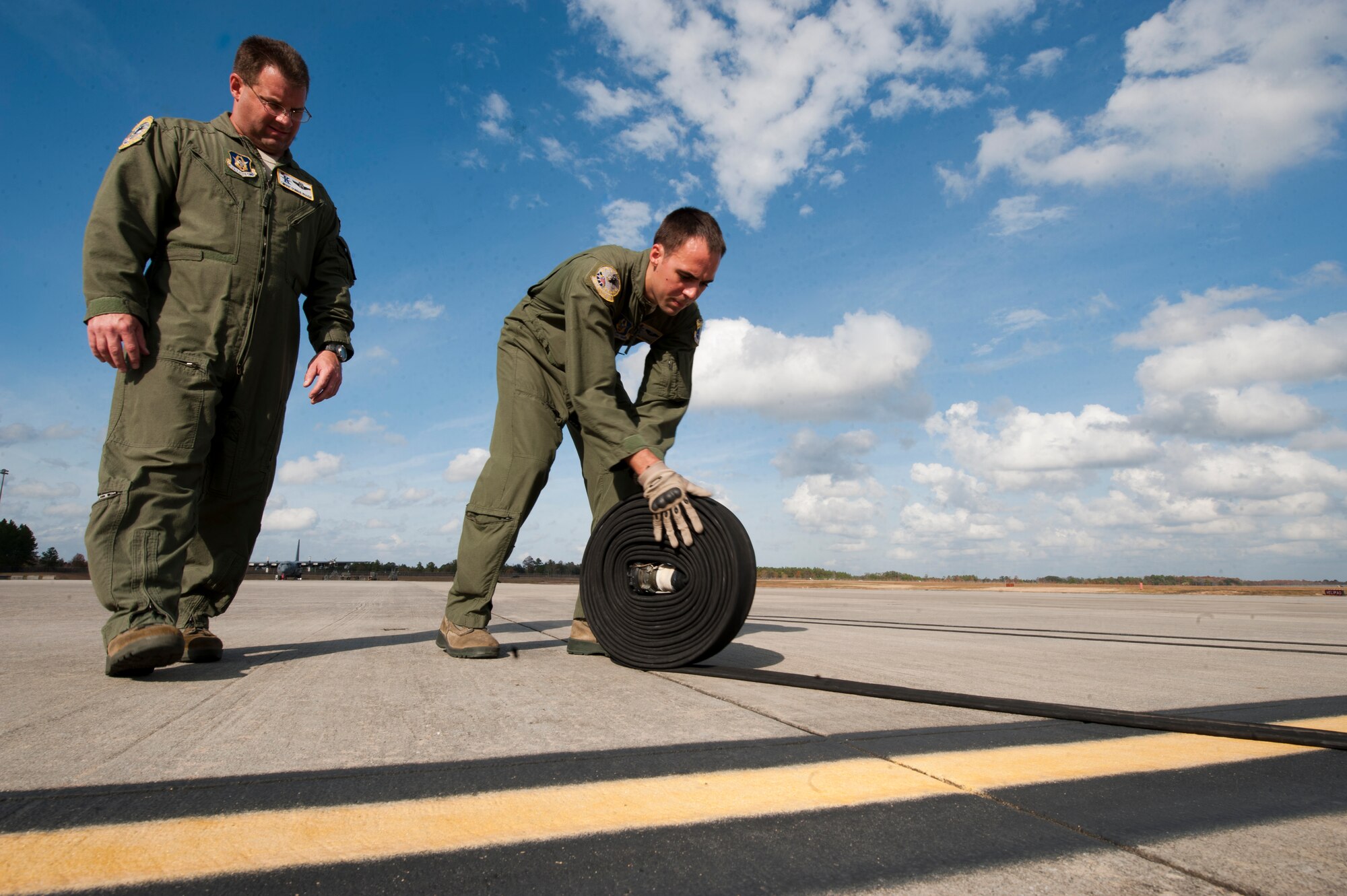 U.S. Air Force Chief Master Sgt. Donnie Rouse,  39th Rescue Squadron based out of Patrick Air Force Base, Fla., watches Senior Airman Mark Theobald, also with the 39th RQS, roll a fuel line to an HC-130P Combat King during a forward area refueling point (FARP) training drill on Moody Air Force Base, Ga., Nov. 15, 2011. FARP missions are conducted when an aircraft does not have in-flight refueling capabilities and cannot reach an airfield. The HC-130P's capability to land in a minimal amount of area allows it to be an ideal air frame to perform FARP missions downrange. (U.S. Air Force photo by Staff Sgt. Joshua J. Garcia/Released)  