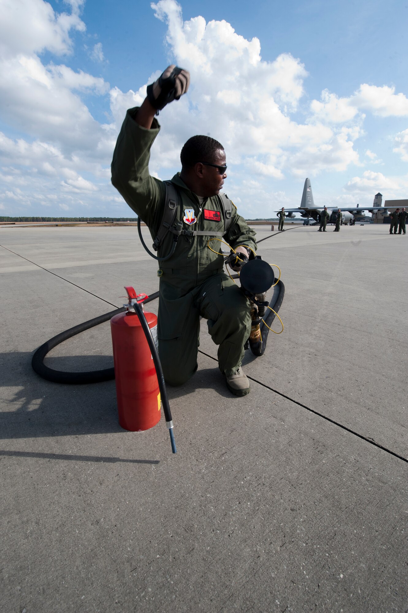 U.S. Air Force Master Sgt. Quetonius Jenkins, 23rd Logistics Readiness Squadron, raises his hand to signal that his forward area refueling point (FARP) is secure and ready to fuel an aircraft during training on Moody Air Force Base, Ga., Nov. 15, 2011. Air Force Special Operations Command once performed all FARP missions for the entire Department of Defense. Air Combat Command has started training Moody Airmen to perform this mission to provide better support for the rescue capability. (U.S. Air Force photo by Staff Sgt. Joshua J. Garcia/Released)    