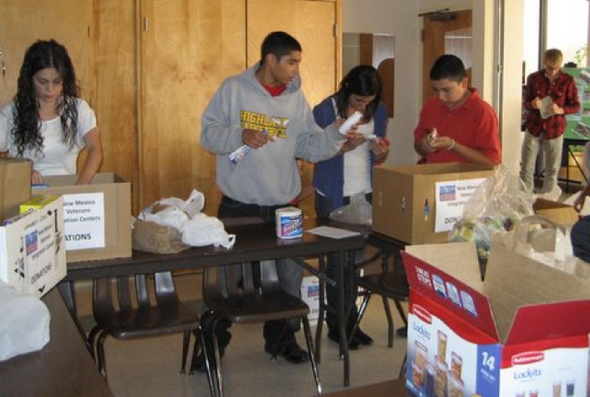 Members of the Kirtland Air Force Base Catholic Community Youth Groups, sort through a variety of donations, including food that was given to homeless veterans.

By Vivian Maheu