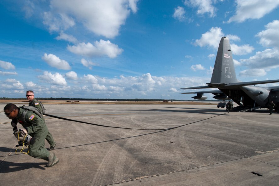U.S. Air Force Master Sgt. Quetonius Jenkins, 23rd Logistics Readiness Squadron, stretches a 300 foot fuel line from an HC-130P Combat King during forward area refueling point (FARP) training on Moody Air Force Base, Ga., Nov. 15, 2011. Jenkins and fellow members performing the drill had 20 minutes to set up the FARP site and 30 minutes to tear down and evacuate the area with little to no evidence of their presence. (U.S. Air Force Photo by Staff Sgt. Joshua J. Garcia/Released)