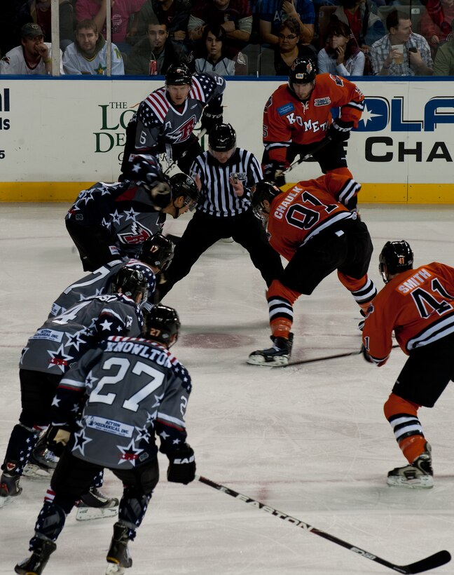 Rapid City Rush and Ft. Wayne Komets hockey players prepare to challenge each other on ice at the Rapid City Rush Military Appreciation Night in honor of Veterans Day at the Rushmore Plaza Civic Center in Rapid City, S.D., Nov. 11, 2011. The Rush hockey players wore special uniforms displaying a patriotic theme as a way to pay homage for the sacrifices retired and active duty U.S. military members have made to protect the country and its freedom. (U.S. Air Force photo by Airman 1st Class Kate Thornton/Released)