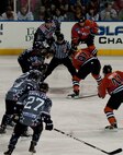 Rapid City Rush and Ft. Wayne Komets hockey players prepare to challenge each other on ice at the Rapid City Rush Military Appreciation Night in honor of Veterans Day at the Rushmore Plaza Civic Center in Rapid City, S.D., Nov. 11, 2011. The Rush hockey players wore special uniforms displaying a patriotic theme as a way to pay homage for the sacrifices retired and active duty U.S. military members have made to protect the country and its freedom. (U.S. Air Force photo by Airman 1st Class Kate Thornton/Released)