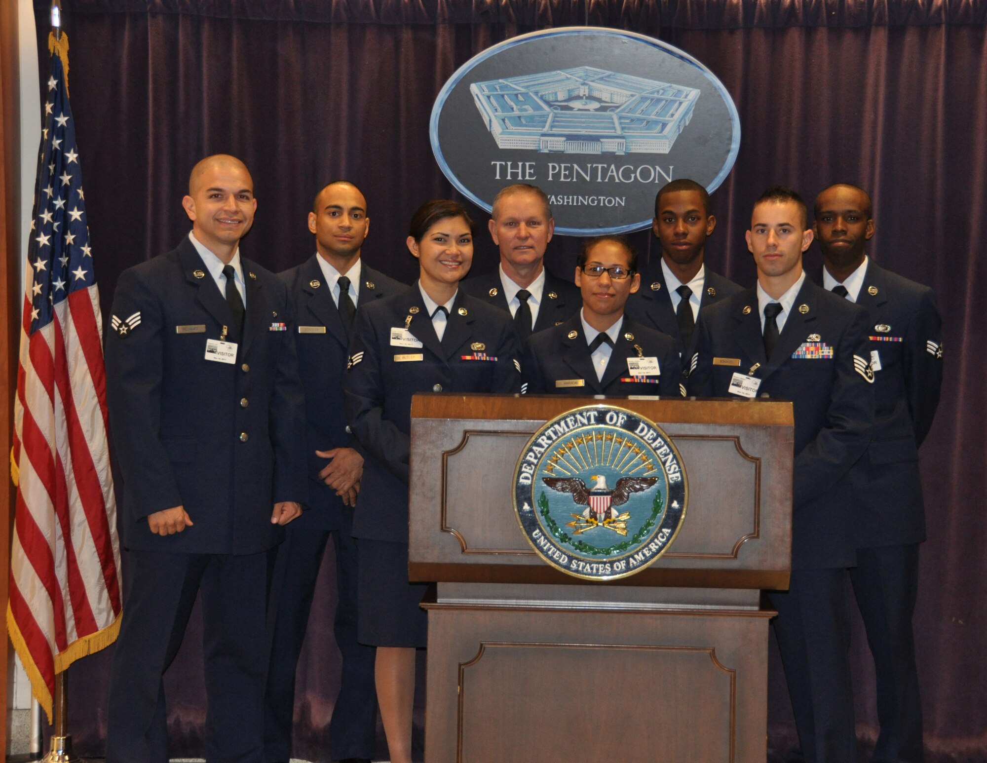 Situated in the Visitor’s Center, eight Dobbins Reservists pose behind a podium in front of the Pentagon seal to commemorate their visit to the Pentagon Nov. 14-15. Dobbins reservists were briefed by Air Force Reserve directorates and afforded an exclusive tour of the Pentagon, which included a tour of the 9/11 Memorial and visit to Air Force Chief of Staff Gen. Norton A. Schwartz’s office. (U.S. Air Force photo/Senior Airman Chelsea Smith)