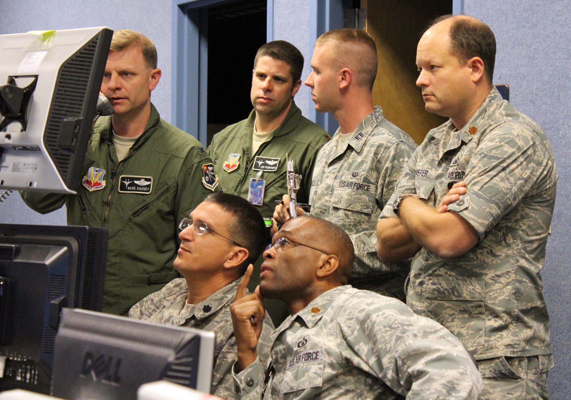 Col. Wade Causey, director of the 601st Air and Space Operations Center’s Combat Operations Division, and other AOC members monitor air traffic and airspace during a joint and bi-national exercise executed through Air Forces Northern’s Distributed Mission Operations system Nov. 17. DMO is a system of inter-connected simulators that allows warfighters from across the U.S. and Canada to participate simultaneously in the same live scenario. (U.S. Air Force Photo by Angela Pope)