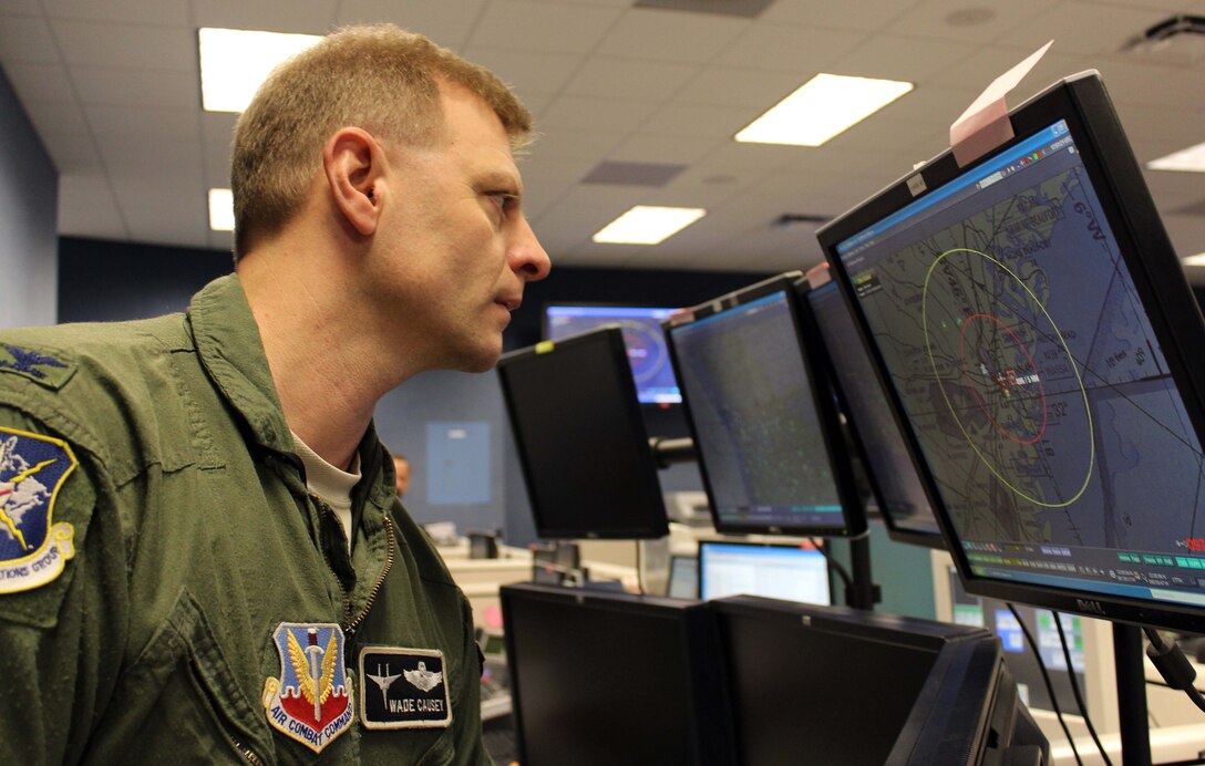 Col. Wade Causey, director of the 601st Air and Space Operations Center’s Combat Operations Division, monitors airspace during a joint and bi-national exercise executed through Air Forces Northern’s Distributed Mission Operations system Nov. 17. DMO is a system of inter-connected simulators that allows warfighters from across the U.S. and Canada to participate simultaneously in the same live scenario. (U.S. Air Force Photo by Angela Pope)