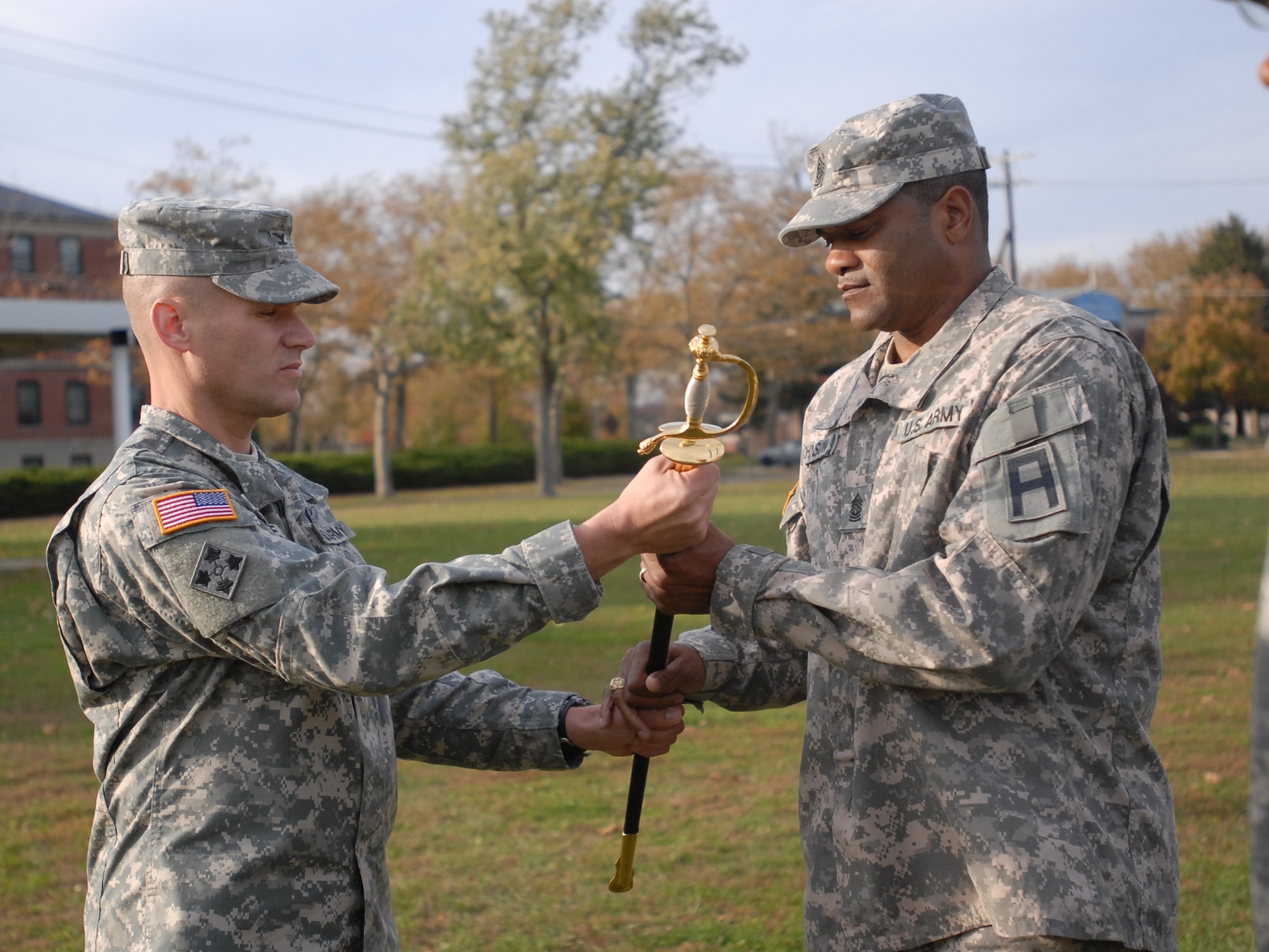 Command Sgt. Maj. Christopher Johnson accepted the noncommissioned officer sword from Col. Craig A. Osborne, 174th Infantry Brigade commander, during a change of responsibility ceremony held at Sharp Field here, Nov. 4. 