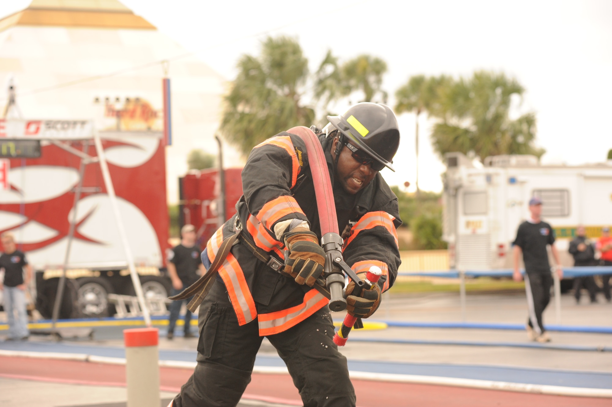 Marcus Shepard, a firefighter from Seymour Johnson Air Force Base, N.C., participates in the hose drag event during the World Firefighter Combat Challenge XX at Myrtle Beach, S.C., Nov. 17, 2011.  This is the fourth of five events in the challenge, during which firefighters drag a fully-loaded firehose 75 feet and through a "saloon door" obstacle in order to knock down a volleyball-sized target with a stream of water. (U.S. Air Force photo/John Van Winkle)