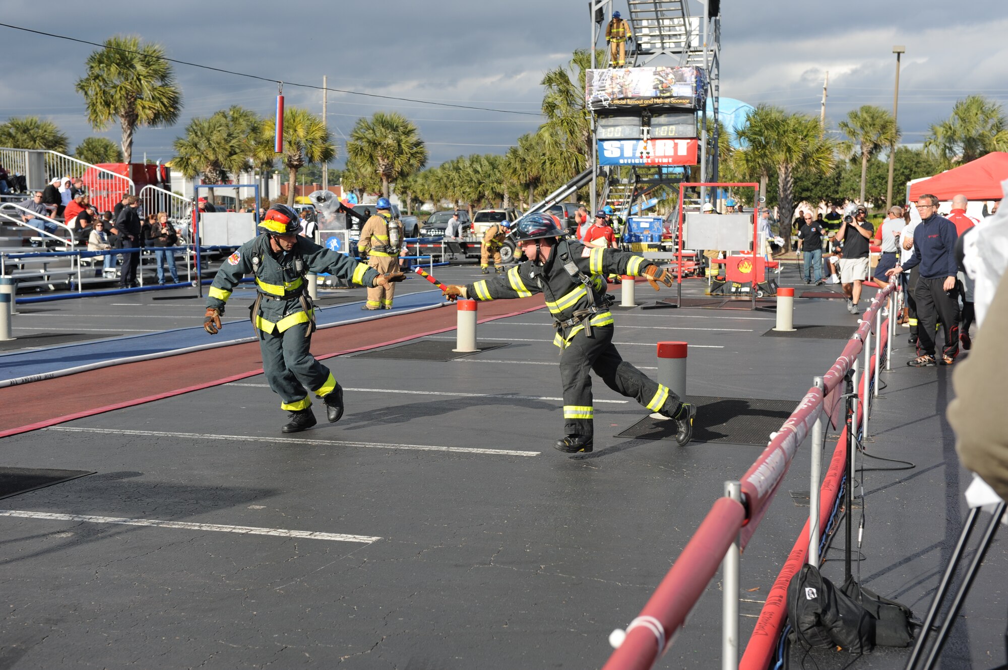 Gerd Mueller, (left) a firefighter from Spangdahlem Air Base, Germany, rakes the handoff from Sascha Rech, a firefighter from Ramstein AB, Germany, during a team relay event at the World Firefighter Combat Challenge XX in Myrtle Beach, S.C., Nov. 17, 2011. Mueller and Rech are part of the four-man Consolidated U.S. Air Forces in Europe team, which includes current and former USAFE firefighters who are now stationed at Spangdahlem AB; Ramstein AB; Aviano AB, Italy; and Shaw AFB, S.C. (U.S. Air Force photo/John Van Winkle)