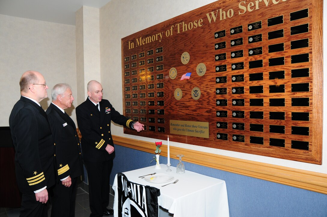 Navy Commander (retired) Wayne Sorrentino (left), NY Naval Militia Rear Admiral F. Robert Danni, and Buffalo Military Entrance Processing Station Commander Lieutenant Commander Keith Archibald view the Warrior Board at the Buffalo MEPS, Niagara Falls Air Reserve Station, NY after the dedication ceremony on Nov. 17, 2011. The Warrior Board honors those military members who processed through MEPS, were from Western New York and who gave the ultimate sacrifice. (U.S. Air Force photo by Peter Borys)