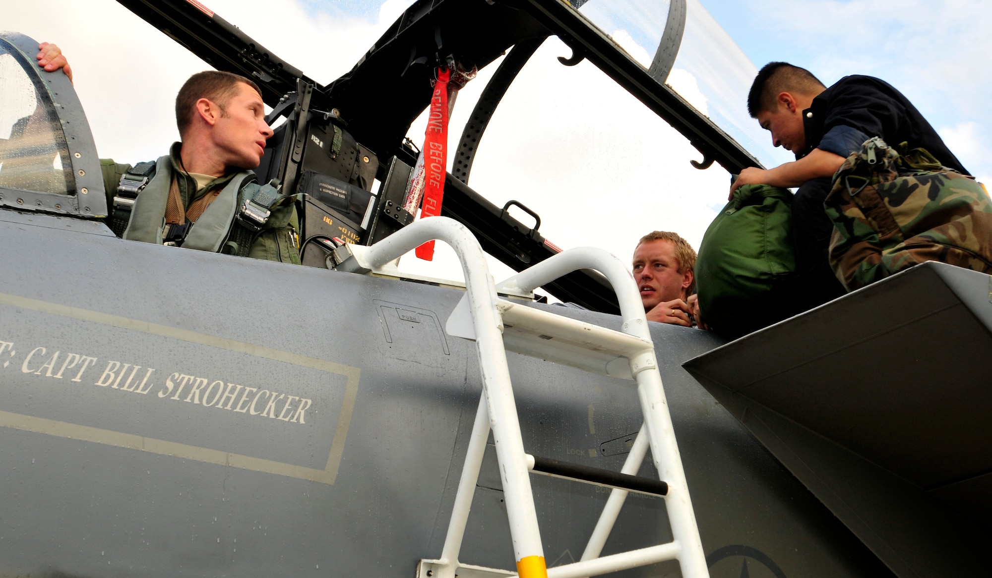 ROYAL AIR FORCE LAKENHEATH, England - (left to right) U.S. Air Force Maj. Mike Conrad, 493rd Fighter Squadron pilot, and Swedish Air Force Capt. Fredrik Bergstrom, 211th Fighter Squadron, go over preparations before take-off as Senior Airman Francisco Lumbreras, 748th Aircraft Maintenance Squadron assistant dedicated crew chief assists Bergstrom with gear Nov. 17, 2011. This is Bergstrom's first time ever in a foreign aircraft. Members from the SAF and the 48th Fighter Wing trained together to increase their interoperability and gather experience with foreign aircraft. (U.S. Air Force photo by Senior Airman Tiffany M. Deuel)
