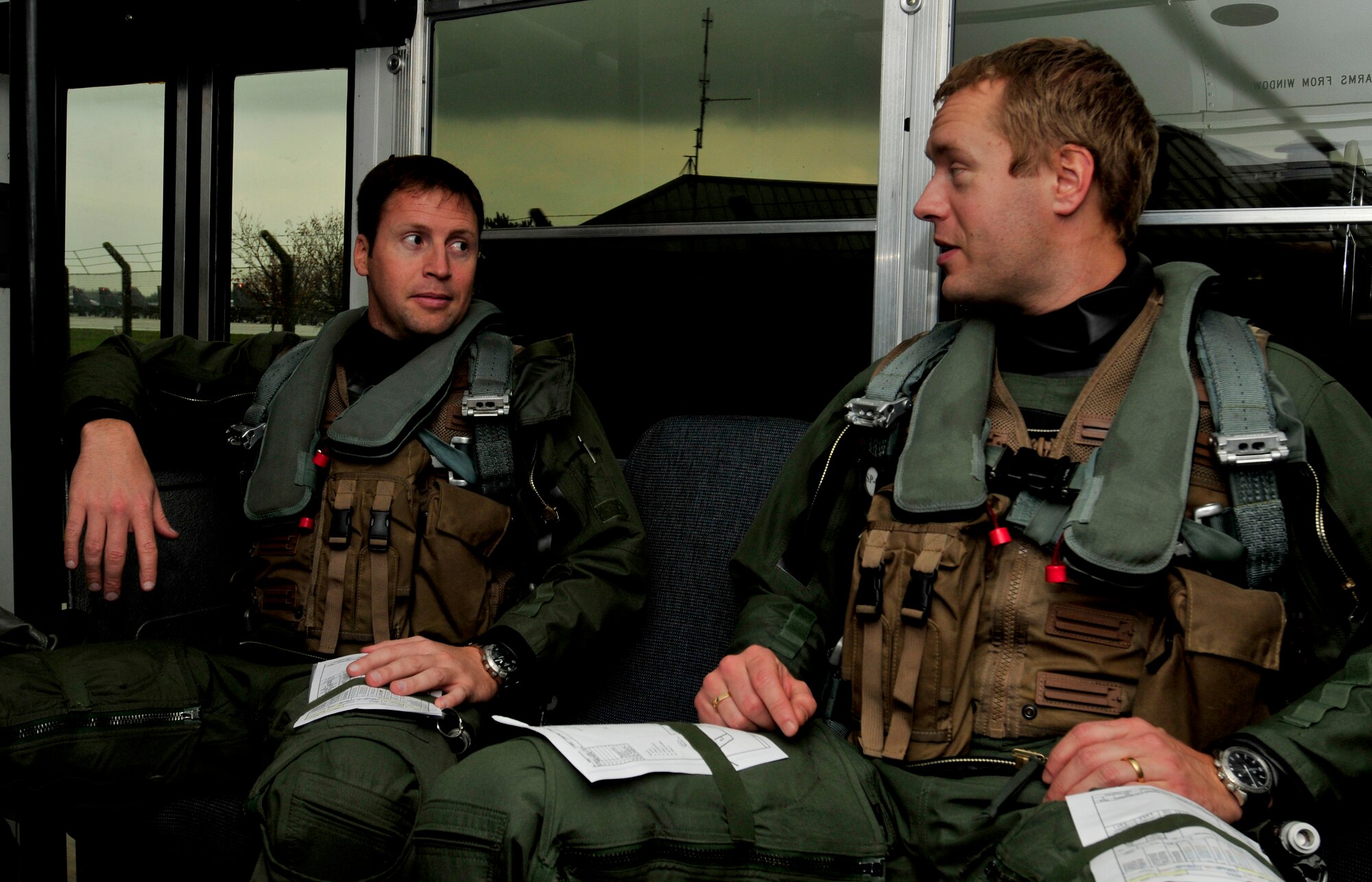 ROYAL AIR FORCE LAKENHEATH, England - U.S. Air Force Capt. Corey Peay, 493rd Fighter Squadron pilot, (left) speaks with Swedish Air Force Capt. Fredrik Bergstrom, 211th Fighter Squadron, on the bus to their jets Nov. 17, 2011. This is Bergstrom's first time in a foreign aircraft. Members from the SAF and the 48th Fighter Wing trained together to increase their interoperability and gather experience with foreign aircraft. (U.S. Air Force photo by Senior Airman Tiffany M. Deuel)