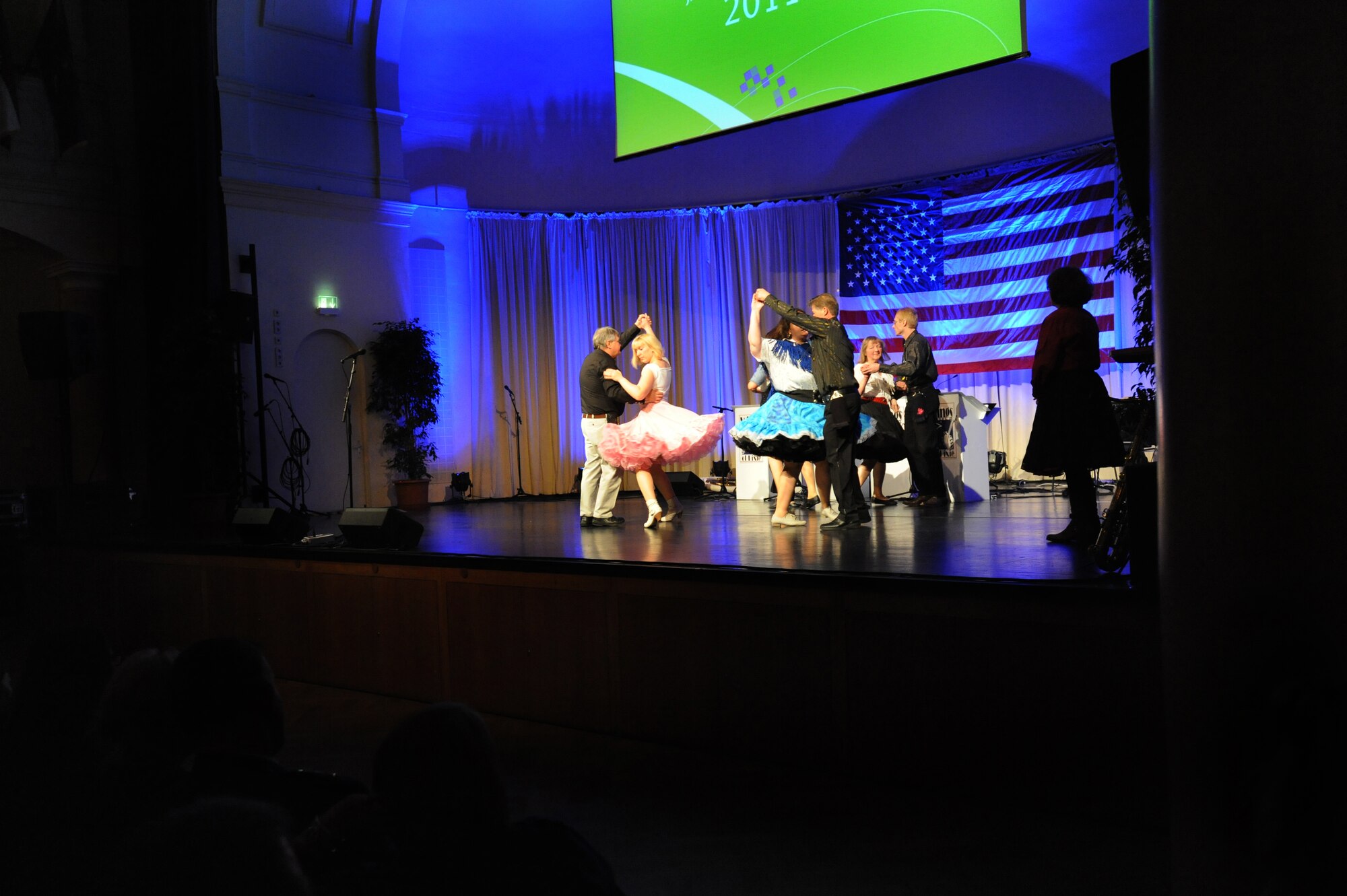 Action Fraction, a square dancing class from Kaiserslautern, performs during the ‘Year of Internationality’ event, Kaiserslautern, Germany, Nov.16, 2011. During the event individuals from the U.S. were given the opportunity to present information and share personal stories about their respective country to the local community. (Air Force photo by Airman 1st Class Caitlin O’Neil-McKeown)