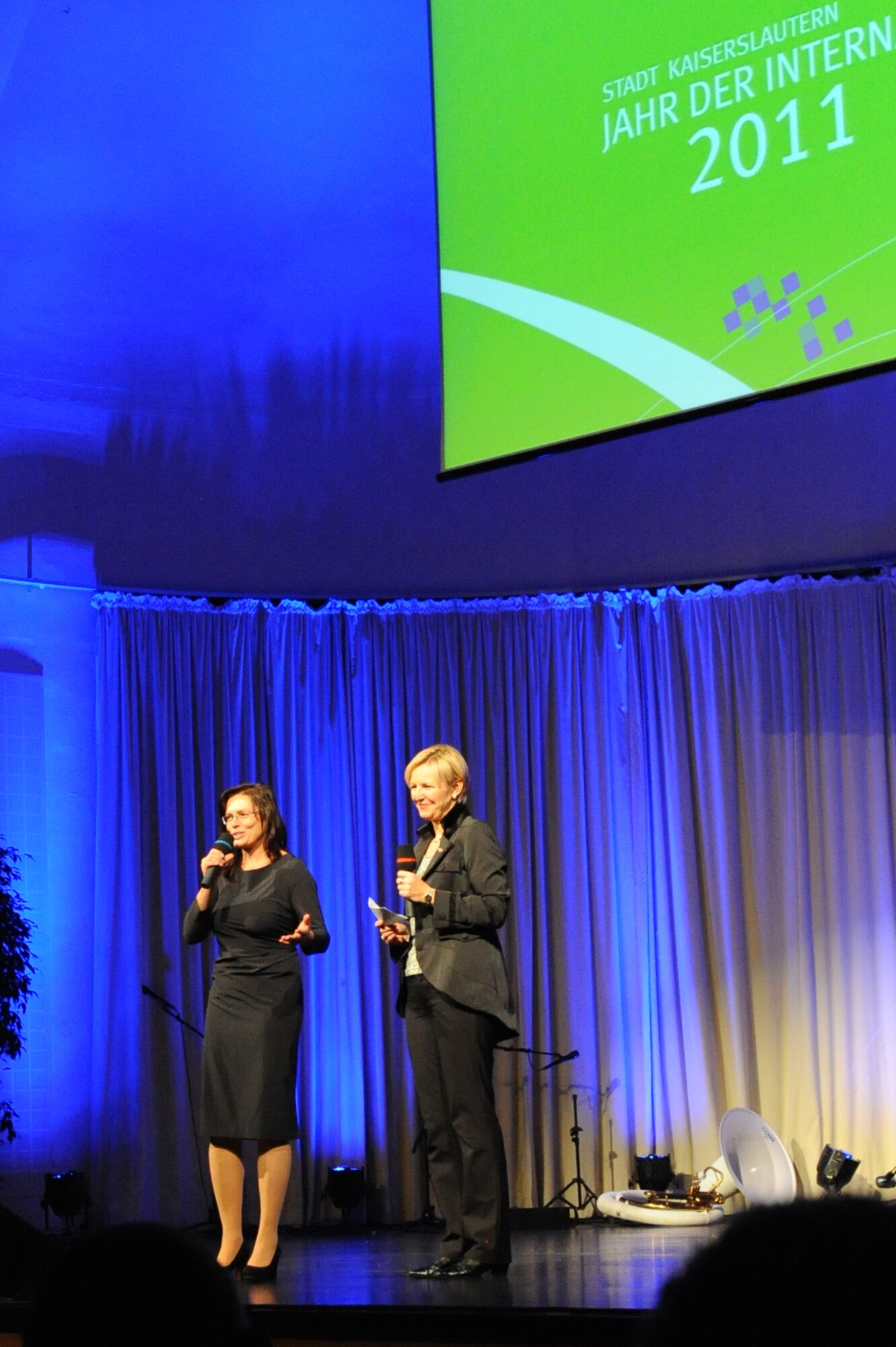 Stefanie Tücking, regional radio station SWR3, thanks Andrea Oliver, Stadtwerke Kaiserslautern, for her coordination of the ‘Year of Internationality’ event, Kaiserslautern, Germany, Nov.16, 2011. During the event individuals from the U.S. were given the opportunity to present information and share personal stories about their respective country to the local community. (Air Force photo by Airman 1st Class Caitlin O’Neil-McKeown)