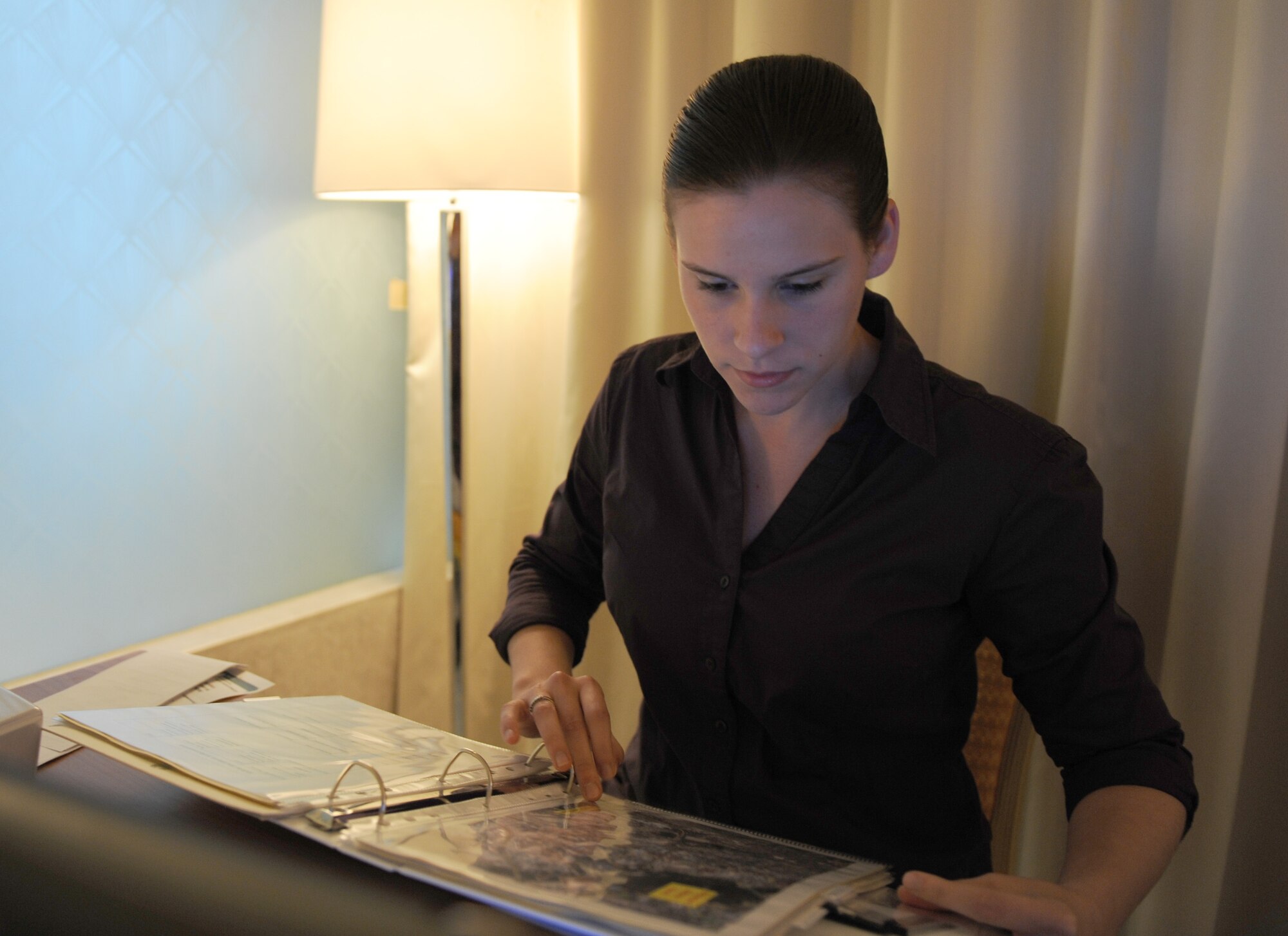 Staff Sgt. Valerie Kalkwarf, an emergency management journeyman from the 380th Expeditionary Civil Engineer Squadron, holds a map cordon overlay for the 2011 Dubai Airshow Nov. 12, 2011. The overlays identify predetermined cordon areas of 500, 1,000 and 2,000 feet that can be used if an incident occurs during the event. Kalkwarf was part of a team of emergency management personnel deployed to the event to develop plans and procedures that ensure the safety of U.S. Department of Defense people and property at the show. The U.S. military is participating in the 2011 Dubai Airshow to enhance interoperability and demonstrate a shared commitment to regional security and stability. Kalkwarf is deployed from Ramstein Air Base, Germany and is from Minonk, Ill. (U.S. Air Force photo/Master Sgt. Chance Babin)