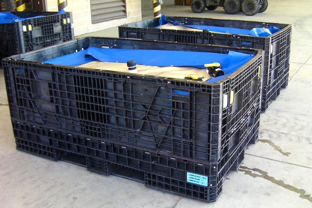 Container equipment systems developed to transport and store water and fuel are ready for a test airdrop on Fort Bragg, N.C., Nov. 9, 2011. Each polypropylene water blivet can hold up to 420 gallons of water or fuel. To comply with current rigging guidelines, soldiers loaded each with only 320 gallons for the certification process.