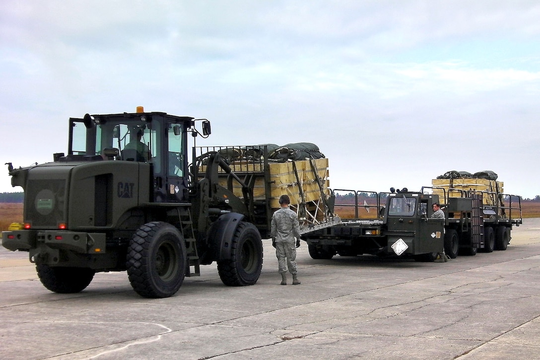 Soldiers load test packages of newly-developed water blivets onto a truck for airdrop from a C-17 Globemaster aircraft on Camp MacKall, N.C., Nov. 9, 2011. The new blivets cost 40 percent less than the current 500-gallon blivet.