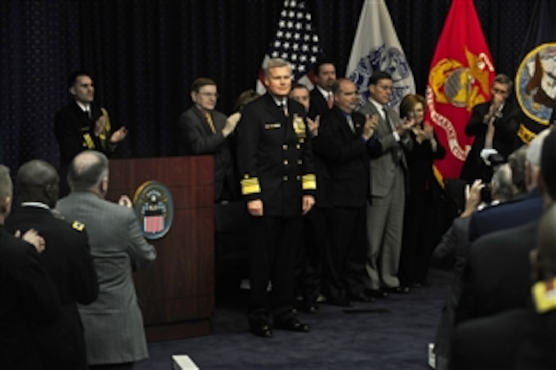 Outgoing Defense Logistics Director Navy Vice Adm. Alan S. Thompson receives a standing ovation during the DLA change of responsibility and retirement ceremony on Fort Belvoir, Va., Nov. 18, 2011. Navy Vice Adm. Mark D. Harnitchek succeeded Thompson as DLA director.