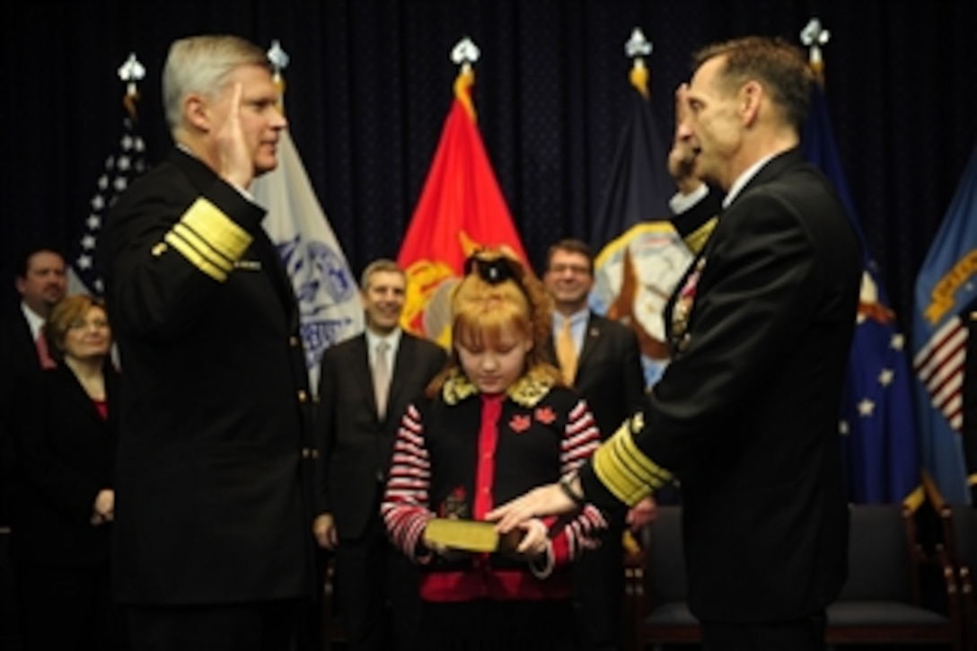 Outgoing Defense Logistics Agency director Navy Vice Adm. Alan S. Thompson, left, administers the oath of office to incoming director Navy Vice Adm. Mark D. Harnitchek during the DLA change of responsibility and retirement ceremony on Fort Belvoir, Va., Nov. 18, 2011. 