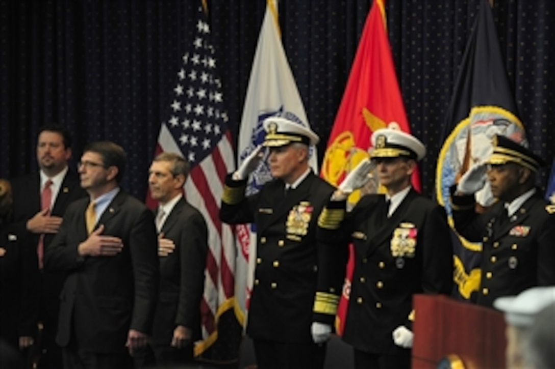 Deputy Defense Secretary Ashton B. Carter, second from left, attends the Defense Logistics Agency change of responsibility and retirement ceremony on Fort Belvoir, Va., Nov. 18, 2011. Navy Vice Adm. Mark D. Harnitchek succeeded Navy Vice Adm. Alan S. Thompson as DLA director. 