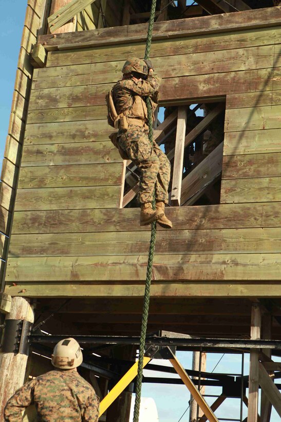 A Marine with the 11th Marine Expeditionary Unit's maritime raid force completes a fast-rope course here Nov. 15. After additional training, the force will embark the amphibious transport dock New Orleans for a seven-month deployment to the Western Pacific and Middle East regions.::r::::n::
