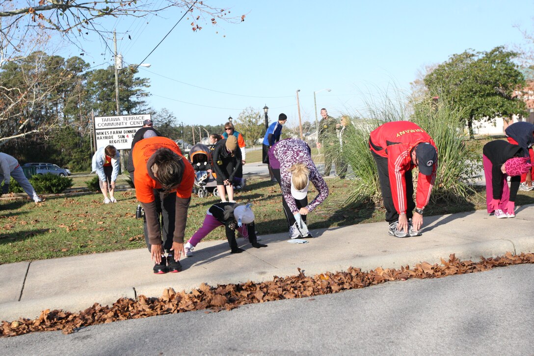 Participants stretch before beginning the Tarawa Terrace November Fun Run, Saturday. Participants braved the chill of the early morning to take part in the monthly fun run, which featured a two and a half-mile run and a one-mile fun run option.