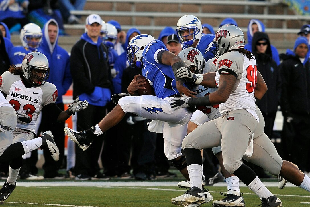 Air Force quarterback Tim Jefferson evades UNLV tacklers during the Falcons-Rebels game at Falcon Stadium Nov. 19, 2011. Jefferson was 7-of-12 for 128 yards passing and had 12 rushes for 81 yards in the Falcons' final home game of the season. (U.S. Air Force photo/Bill Evans)