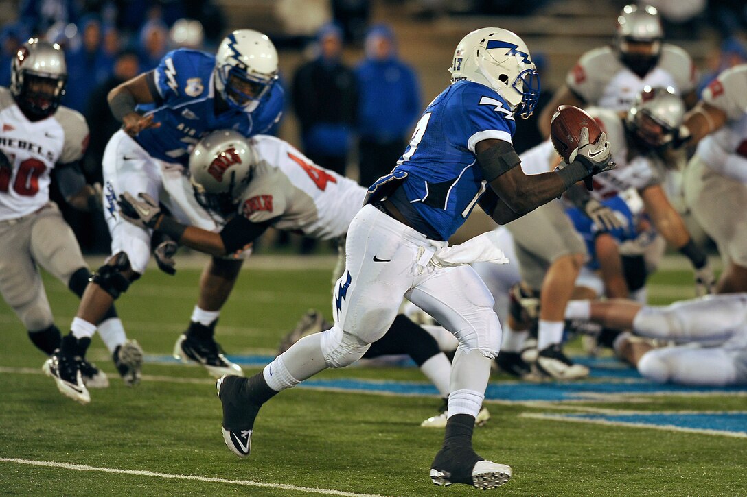 Air Force running back Asher Clark takes a pitch from quarterback Tim Jefferson in the Air Force-UNLV game Nov. 19, 2011. Clark, a senior and native of Lawrenceville, Ga., became Air Force's second-leading all-time rusher with 169 yards and a touchdown on 15 carries. (U.S. Air Force photo/Bill Evans)