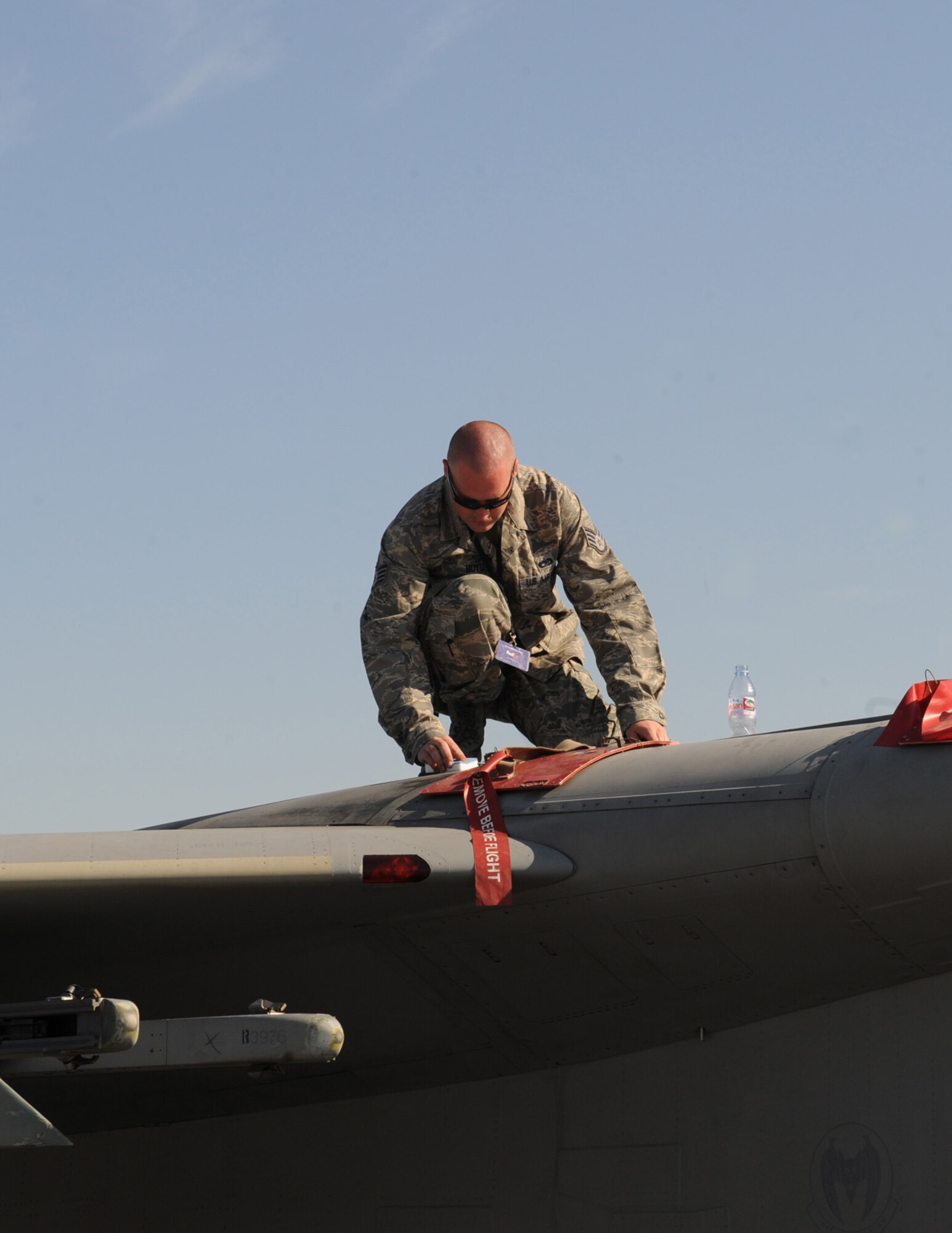 Staff Sgt. Ryan Boyd, an aircraft maintainer from the 380th Air Expeditionary Wing, cleans an F-15 Eagle before the start of the 2011 Dubai Air Show, Nov. 13, 2011. Boyd was part of a team of maintainers and pilots manning a static display of the aircraft at the international event, which was held at the Dubai International Airport Nov. 13-17, 2011. The U.S. military showcased a variety of aircraft at the event to highlight military air power capabilities. (U.S. Air Force photo/Master Sgt. Chance Babin)