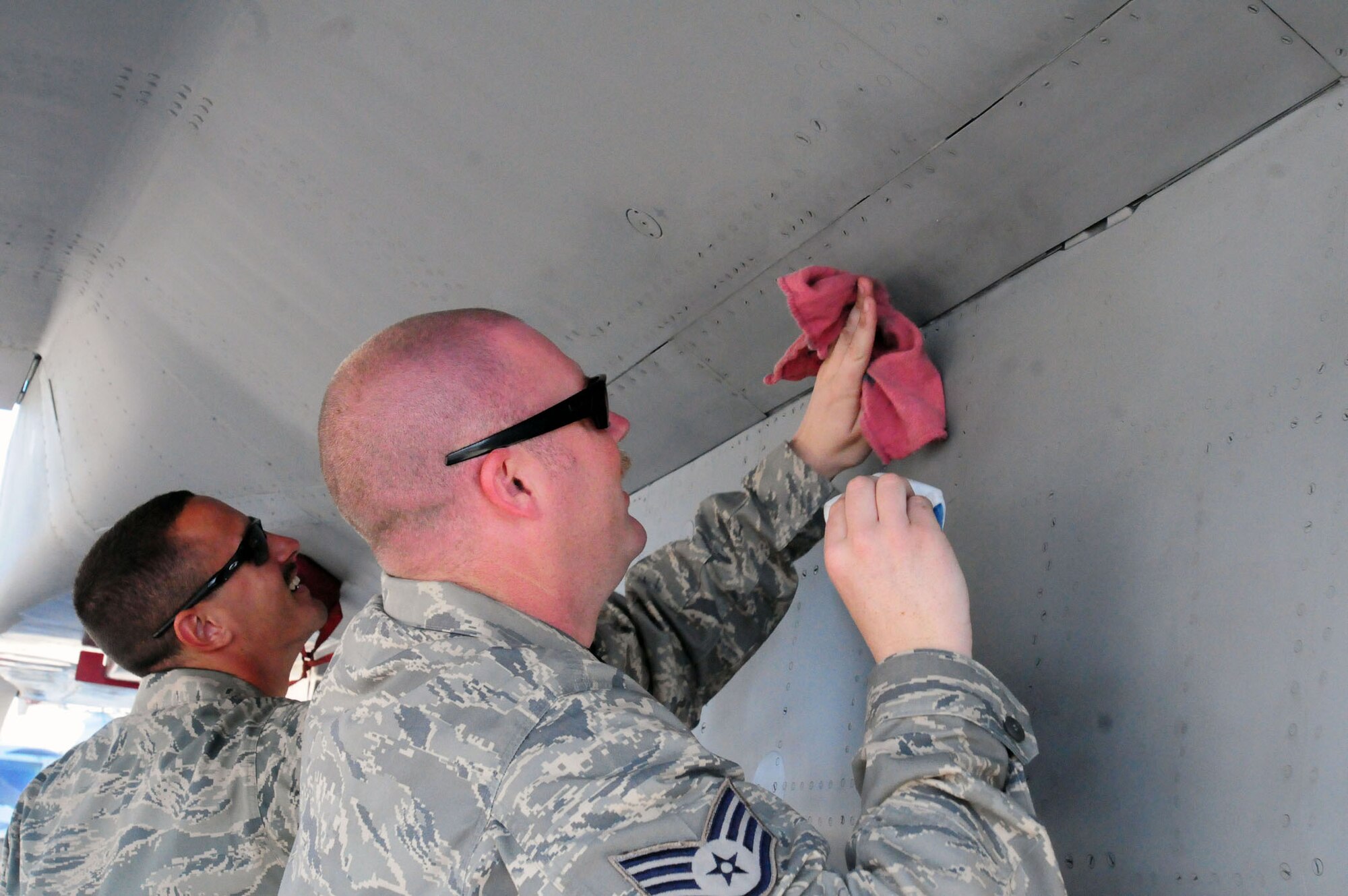Airman 1st Class Brandon Coffill (left) and Staff Sgt. Ryan Boyd, aircraft maintainers from the 380th Air Expeditionary Wing, clean an F-15 Eagle before the start of the 2011 Dubai Air Show, Nov. 13, 2011. Boyd and Coffill were part of a team of maintainers and pilots manning a static display of the aircraft at the international event, which was held at the Dubai International Airport Nov. 13-17, 2011. The U.S. military showcased a variety of aircraft at the event to highlight military air power capabilities. (U.S. Air Force photo/Capt. Gina Vaccaro McKeen)