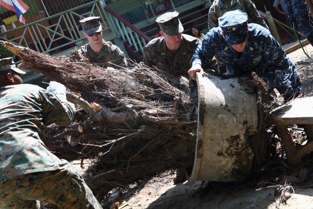 U.S. service members assisting the local community remove fallen debris at the Sanamchai School in Lop Buri, Thailand, Nov. 20. U.S. service members together with the Royal Thai Army assisted Thai citizens with cleaning a school here Nov. 20 in the aftermath of serious flooding that has affected much of the country. U.S. forces continue to support the Royal Government of Thailand in its flood relief efforts.