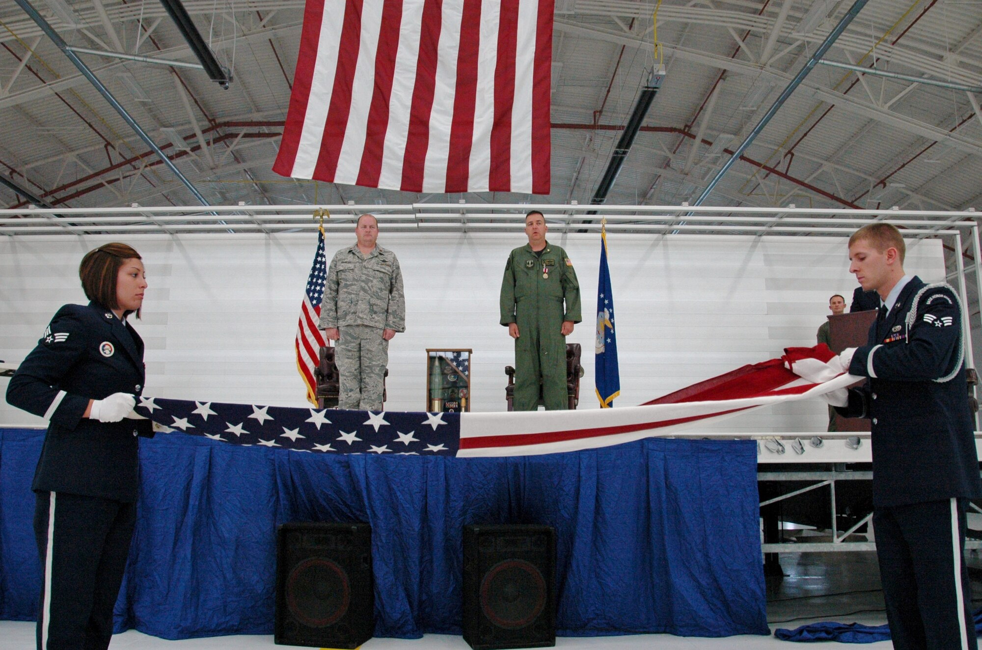 Senior Airmen Rachelle Goldsmith and William Horne of the Eglin Air Force Base Honor Guard perform a flag folding ceremony for a retiring reservist at Duke Field, Fla., recently. The Eglin Honor Guard routinely performs traditional honors for Duke Field ceremonies as part of their overall support to regional military units.  (U.S. Air Force photo/Dan Neely)