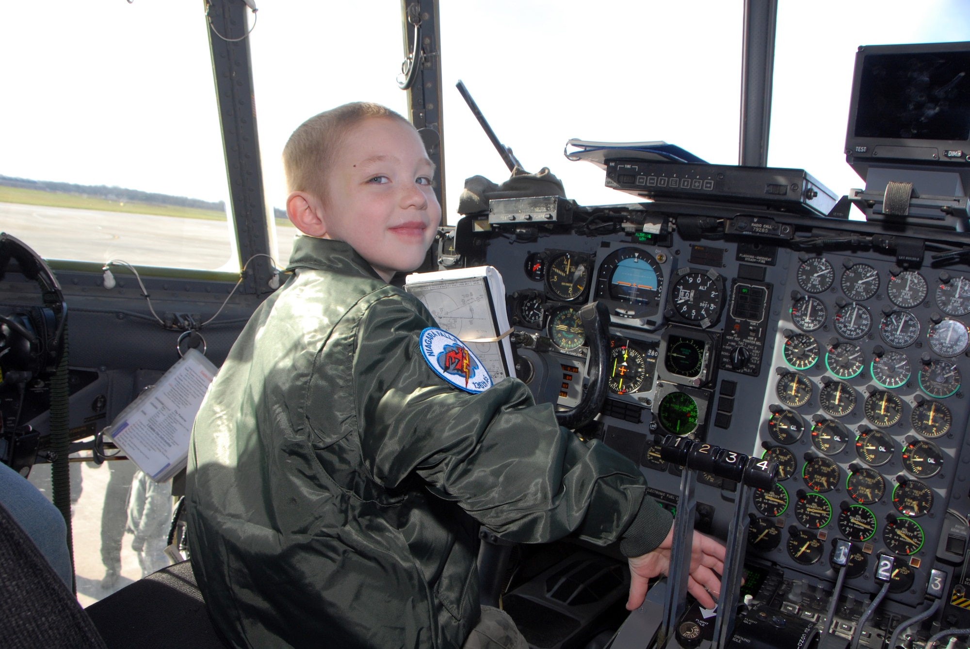 Five-year-old cancer survivor, Donovan Benzin became a Guardsman for a day at the 107th Airlift Wing, Niagara Falls ARS. Here he is exploring the cockpit controls of the C-130 aircraft.