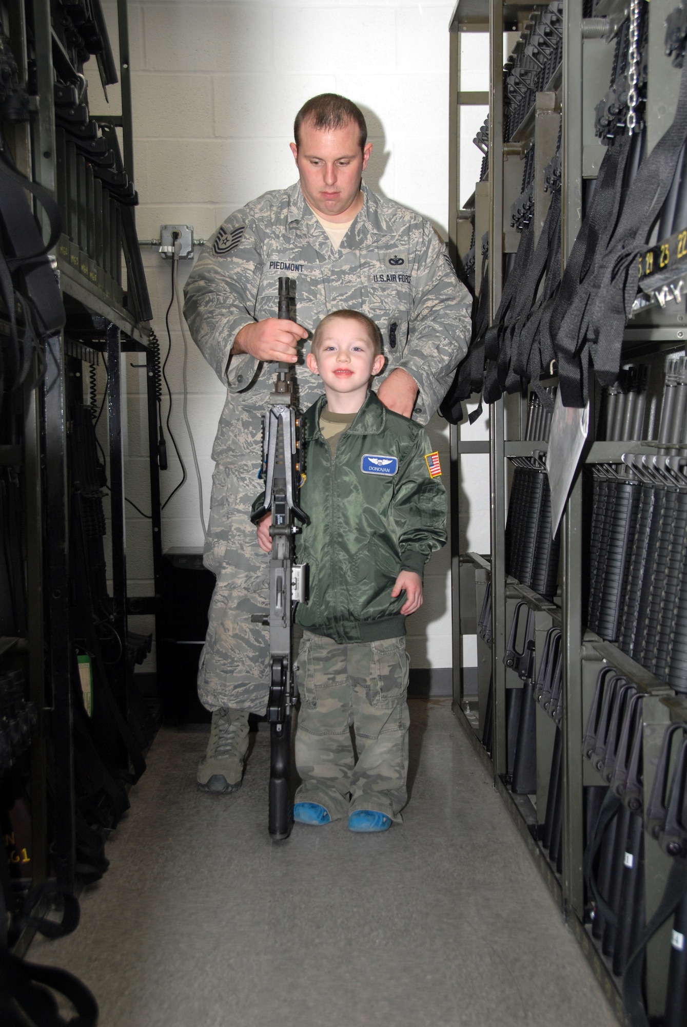 Five-year-old cancer survivor, Donovan Benzin became a Guardsman for a day at the 107th Airlift Wing, Niagara Falls ARS. Here he is touring the arms vault with Tech. Sgt Adam Piedmont. He would like to be a military policeman when her grows up.