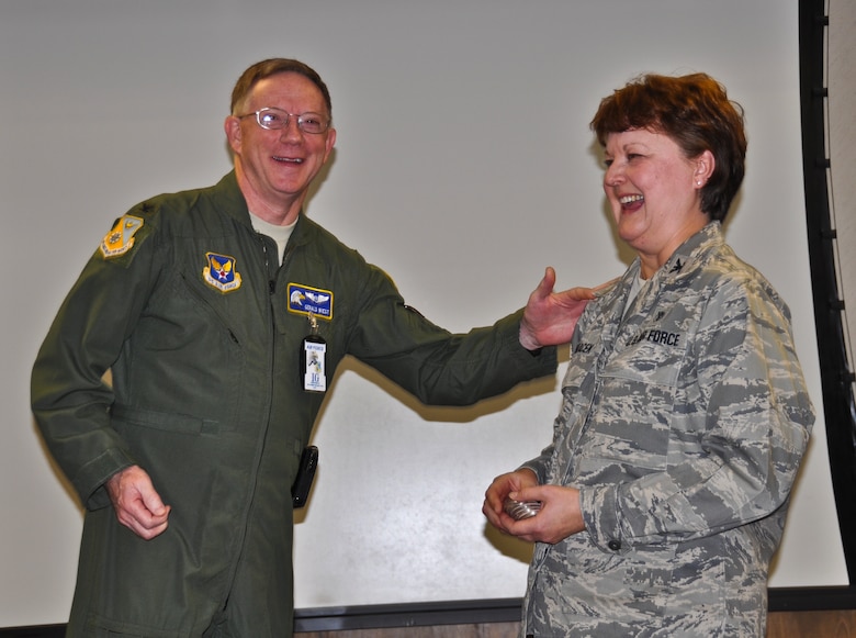 Col. Gerald Wiest, an inspector general with the Air Force Inspection Agency, receives a 128th Air Refueling Wing medical group coin from Col. Eileen Panacek, commander of the medical group, on Sunday, November 20, 2011.  Air Force inspectors completed a comprehensive review of the 128th Air Refueling Wing's medical group over the course of four days, and on the fifth day, the medical group was awarded an 'Excellent' rating.  Air National Guard photo by Staff Sgt. Jeremy Wilson.