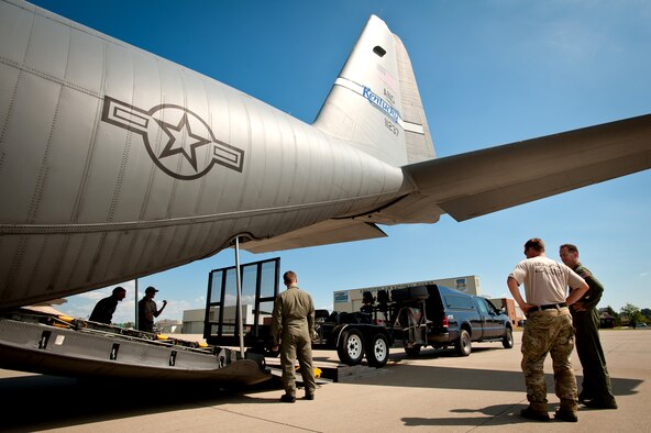 Members of the 123rd Airlift Wing load a truck and trailer packed with rescue gear onto a Kentucky Air Guard C-130 as the unit prepares to deploy Sept. 28, 2011, from Louisville, Ky., to Joint Base McGuire-Dix-Lakehurst, N.J., where Kentucky Airmen were expected to stage for rescue operations in the aftermath of Hurricane Irene. The deployment was called off just prior to the Airmen's departure when damage from Irene was found to be less extensive than anticipated. (U.S. Air Force photo by Maj. Dale Greer)