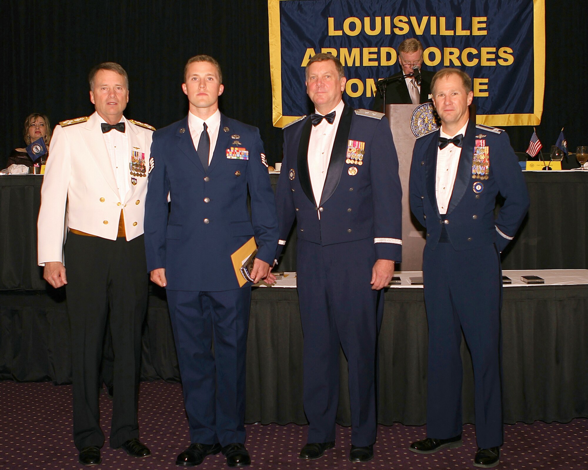 Staff Sgt. Jeff Kinlaw (second from left), a combat controller in the Kentucky Air National Guard's 123rd Special Tactics Squadron, was honored with the Patriot Award for outstanding military service during the 92nd-annual Louisville Armed Forces Committee Dinner, held May 20, 2011, at the Galt House in Louisville, Ky. Presenting the award are (from left to right) Adm. James A. "Sandy" Winnefeld Jr., commander of U.S. Northern Command and the North American Aerospace Defense Command; Maj. Gen. Edward W. Tonini, Kentucky's adjutant general; and Col. Steven Bullard, vice commander of the Kentucky Air National Guard's 123rd Airlift Wing. (Courtesy photo)