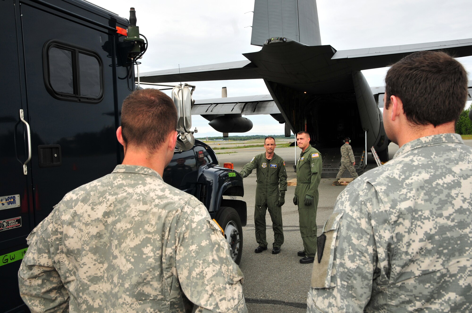 Master Sgt. Clint Stinnett and Staff Sgt. Jerry Passafiume, loadmasters from Kentucky Air National Guard's 165th Airlift Squadron, size up a communications truck July 10, 2011, in Anchorage, Alaska, before marshaling it onto a C-130 Hercules aircraft. The truck was bound for Volk Field, Wis., to be used in Operation Joint Patriot. (U.S. Air Force photo by Staff Sgt. Jason Ketterer)