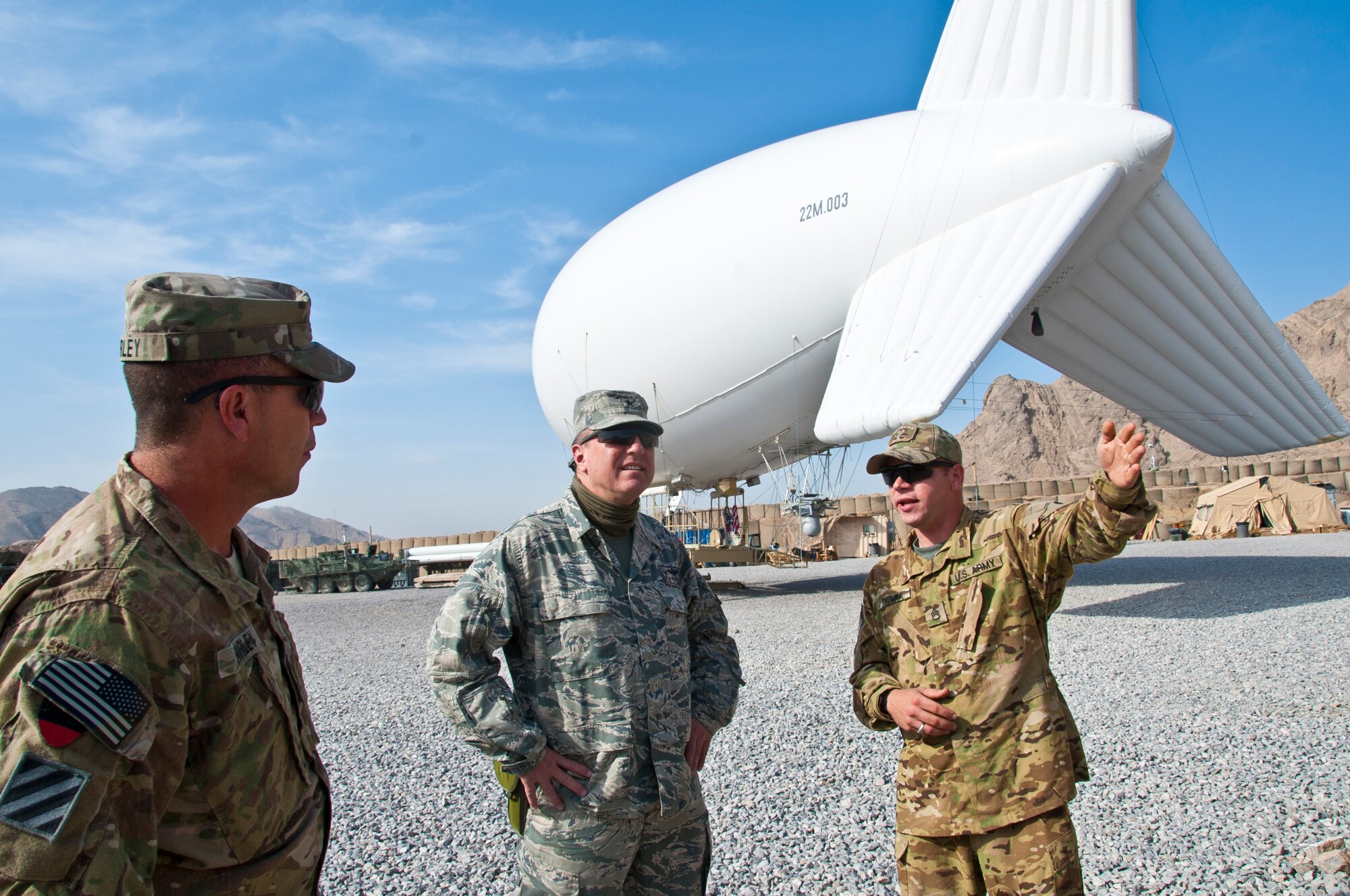 Army Staff Sgt. James Thomas (right) speaks to Air Force Brig. Gen. Jeffrey Kendall, Kandahar Airfield commander, and Army Command Sgt. Maj. Michael Shirley, COMKAF senior-enlisted adviser, at Forward-Operating Base Luke Nov. 15, 2011. This was Kendall's last visit to FOB Luke before the transfer of authority ceremony. (U.S. Air Force photo by Senior Airman David Carbajal)