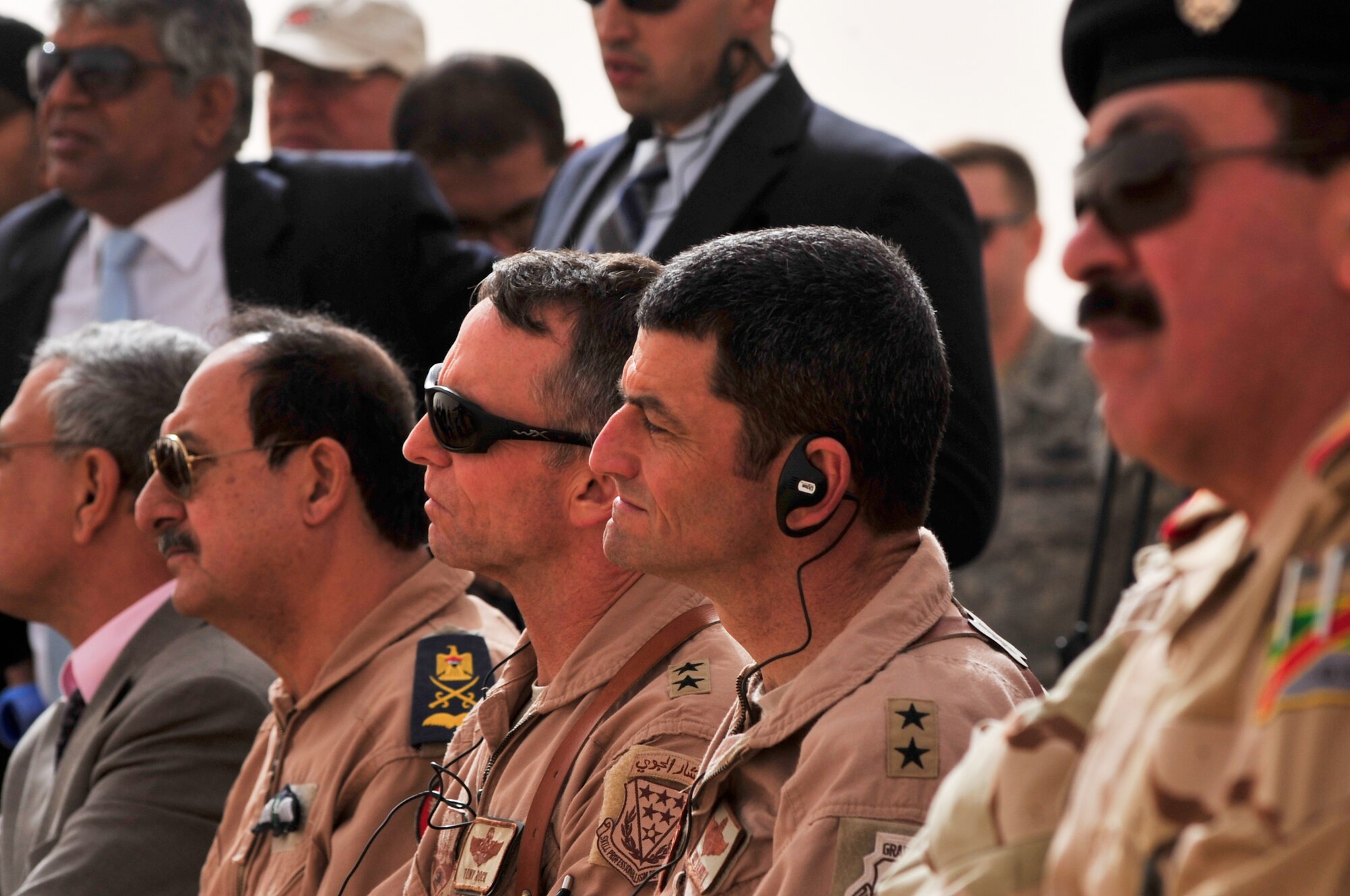 Maj. Gen. Tony Rock, 321st Air Expeditionary Wing commander and Iraqi Training and Advisory Mission-Air director (left), and Maj. Gen. Russ Handy, 9th Air and Space Expeditionary Task Force-Iraq commander and Air Component Coordination Element-Iraq director, listen as staff Lt. Gen. Anwer Amin, the commander of the Iraqi air force, conducts a press conference Nov. 8, 2011, in Western Iraq. Amin told the Iraqi and Pan-Arab media Iraq's purchase of 18 F-16C Fighting Falcons, for their future air defense, will encourage and strengthen the strategic partnership between the U.S. and Iraq. He conducted the press conference in front of an F-16 static display
provided by the 125th Expeditionary Fighter Squadron, an Oklahoma Air National Guard unit providing top cover in Iraq for U.S. service members. When the Iraqi F-16s are delivered, most likely sometime in late 2014 or 2015, Iraq will have the most advanced multi-role fighter aircraft in the world. (U.S. Air Force photo/Master Sgt. Cecilio Ricardo)