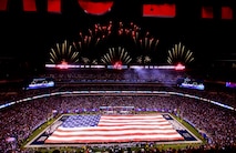 Marines, Sailors, Coast Guardsmen, Airmen and Soldiers unfurled an American Flag across the field during a pre-game ceremony before the New York Giants vs. Philadelphia Eagles game, Nov. 20. The Marine Corps Base Quantico Band performed at half time and 100 service members presented the large flag during the National Anthem.