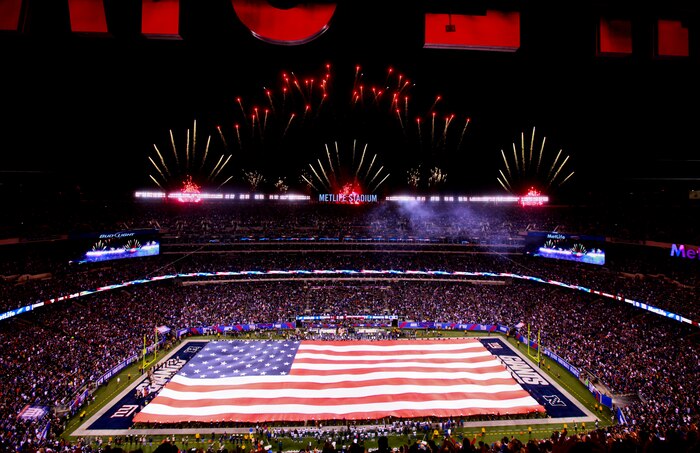 Marines, Sailors, Coast Guardsmen, Airmen and Soldiers unfurled an American Flag across the field during a pre-game ceremony before the New York Giants vs. Philadelphia Eagles game, Nov. 20. The Marine Corps Base Quantico Band performed at half time and 100 service members presented the large flag during the National Anthem.