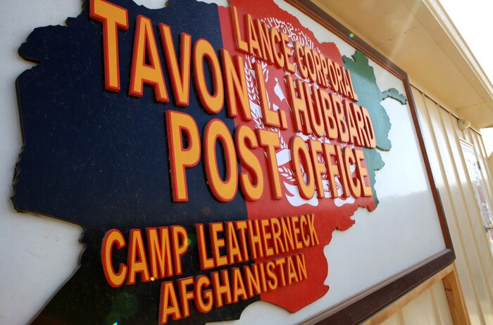 The entrance to the new postal facility aboard Camp Leatherneck, Afghanistan, is adorned with a sign dedicating it to Lance Cpl. Tavon L. Hubbard, who was killed in support of Operation Iraqi Freedom.  More than 10,000 pounds of mail is sorted and delivered at the facility on a daily basis.  (U.S. Marine Corps photo by Cpl. Katherine M. Solano)