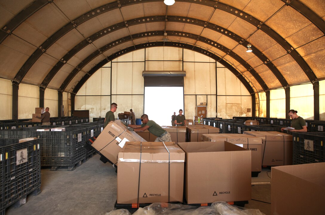 Marines with the 2nd Marine Logistics Group (Forward) Postal Detachment sort through more than 10,000 pounds of packages and letters during a mail delivery aboard Camp Leatherneck, Afghanistan, Nov. 18.  Twenty-four servicemembers joined the postal Marines to work through the holiday rush as part of Operation North Pole.  (U.S. Marine Corps photo by Cpl. Katherine M. Solano)