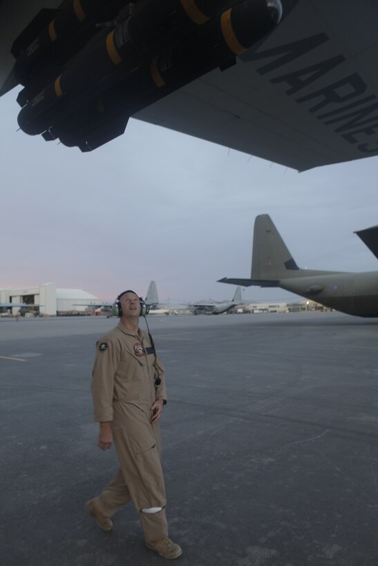 Capt.  Jason Dale inspects the AGM- 114 Hellfire missiles mounted to a KC-130J Hercules before flight at Kandahar Airfield, Afghanistan, Nov. 21. Dale, from Versailles, Ky., is a KC-130J Hercules pilot for the Harvest Hawk equipped aircraft Marines use to provide close-air support for coalition ground forces in Afghanistan. To learn more about Marines in Afghanistan, join them at http://www.facebook.com/regionalcommandsouthwest.