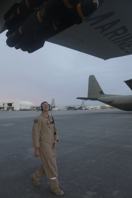 Capt.  Jason Dale inspects the AGM- 114 Hellfire missiles mounted to a KC-130J Hercules before flight at Kandahar Airfield, Afghanistan, Nov. 21. Dale, from Versailles, Ky., is a KC-130J Hercules pilot for the Harvest Hawk equipped aircraft Marines use to provide close-air support for coalition ground forces in Afghanistan. To learn more about Marines in Afghanistan, join them at http://www.facebook.com/regionalcommandsouthwest.