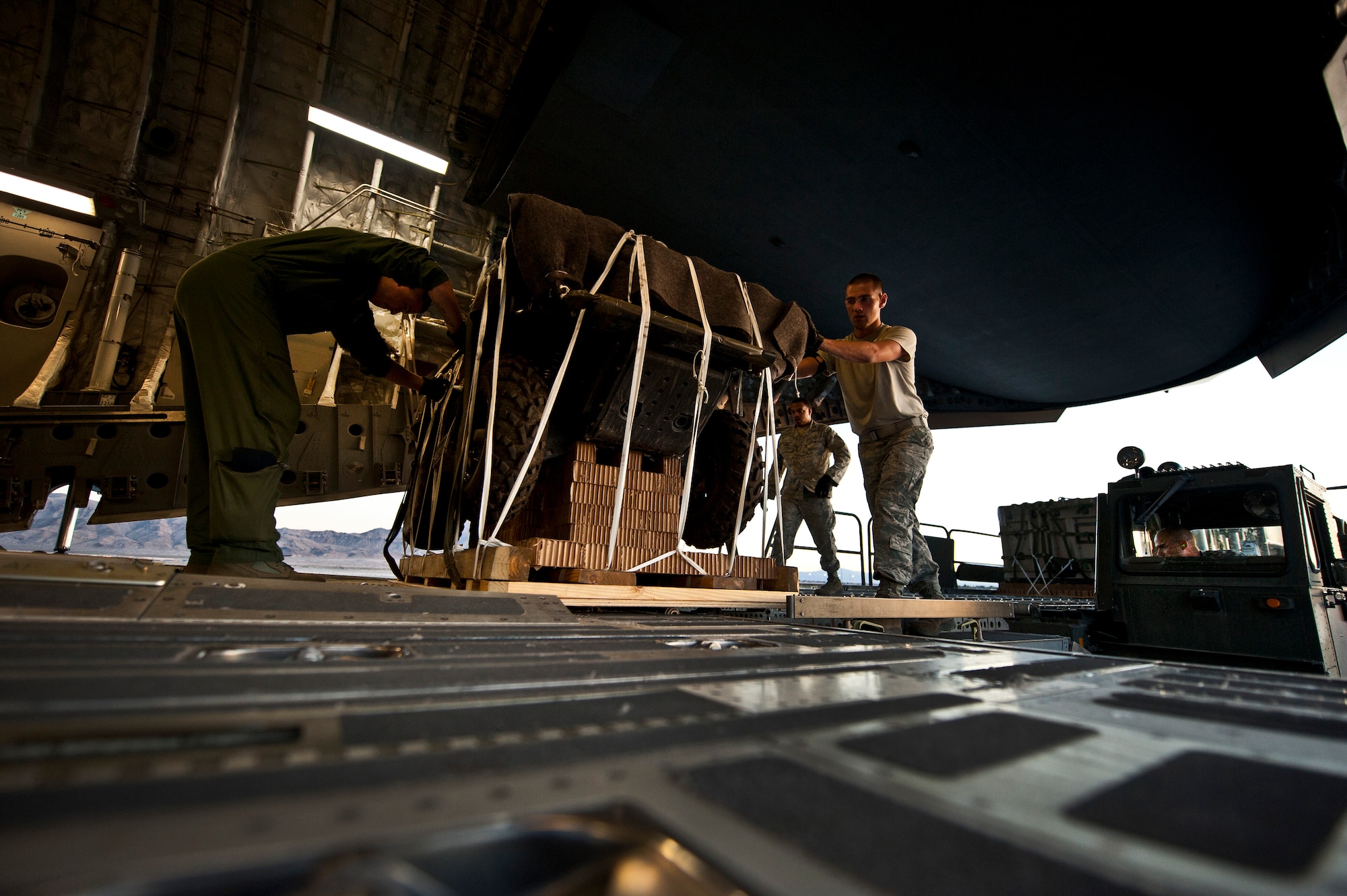 U.S. Air Force Airmen push cargo on to a C-17 Globemaster during the Mobility Air Forces Exercise on Nov. 15, 2011, at Nellis Air Force Base, Nev. The C-17 and C-130 Hercules cargo aircraft will assemble in aerial formations over the Nevada Test and Training Range to conduct air and ground operations as part of the bi-annual U.S. Air Force Weapons School MAFEX. (U.S. Air Force photo by Airman 1st Class George Goslin/Released)
