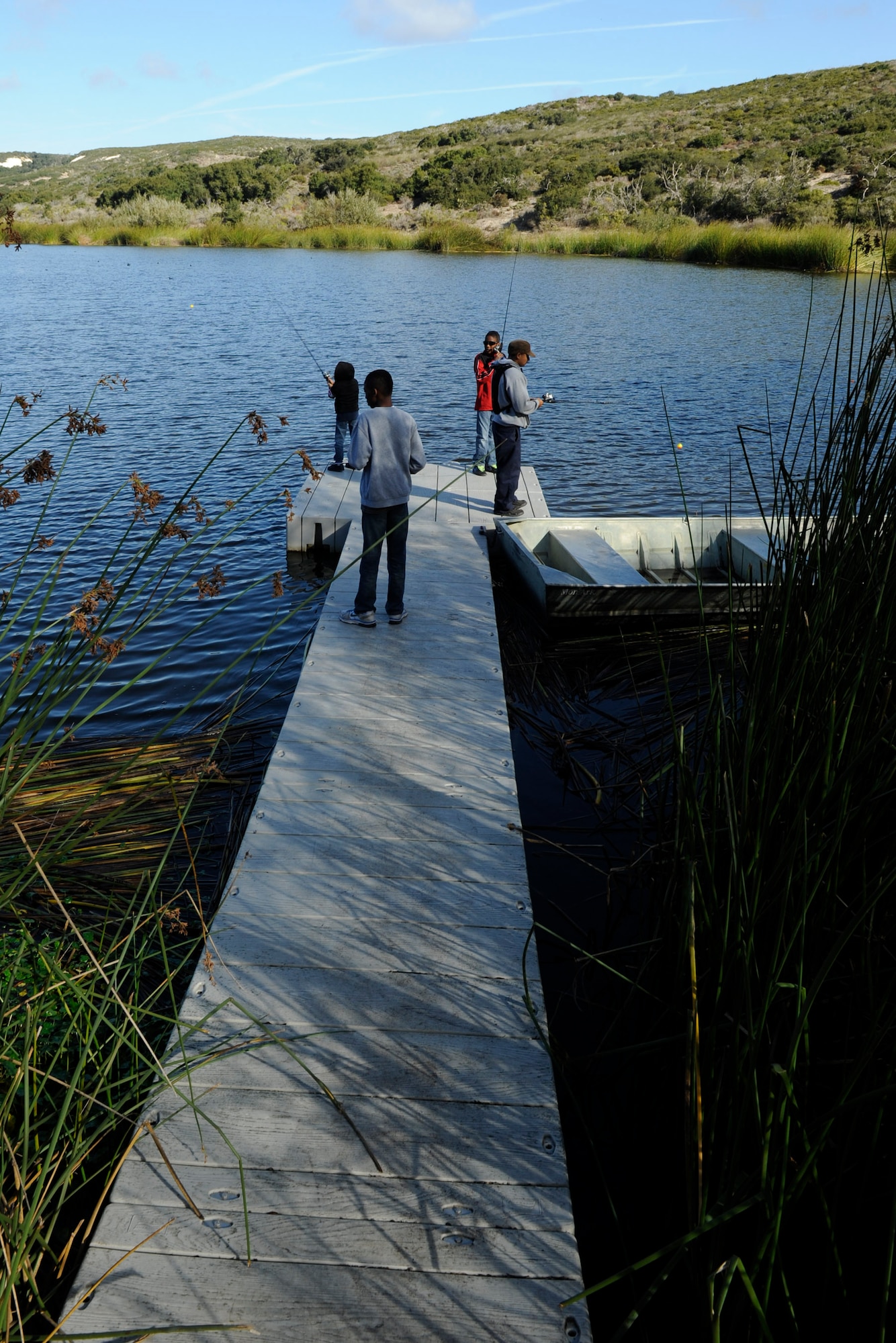 VANDENBERG AIR FORCE BASE, Calif. -- A family from Vandenberg fish at Lower Pine Canyon Lake here Saturday, Nov. 19, 2011. The fishing event was part of the Take Me Fishing campaign, which is a nation wide program that encourages people to get out and go fishing. (U.S. Air Force photo/Staff Sgt. Levi Riendeau)