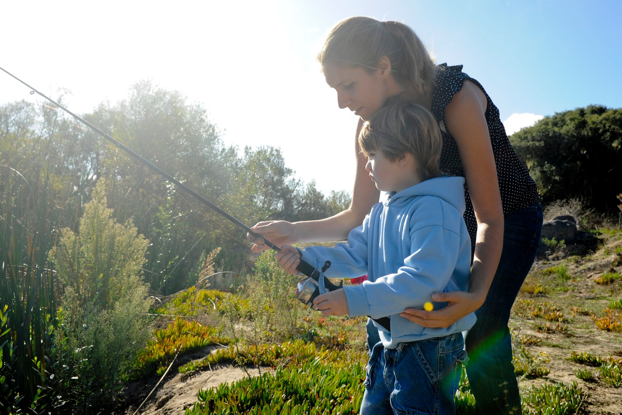 VANDENBERG AIR FORCE BASE, Calif. -- Jacqueline Oliver helps Wyatt Oliver, age 3, fish at Lower Pine Canyon Lake here Saturday, Nov. 19, 2011. The fishing event was part of the Take Me Fishing campaign, which is a nation wide program that encourages people to get out and go fishing. (U.S. Air Force photo/Staff Sgt. Levi Riendeau)