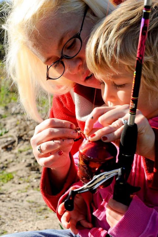 VANDENBERG AIR FORCE BASE, Calif. -- Sarah Morton helps Lexie Morton, age 3, put a worm on a hook at Lower Pine Canyon Lake here Saturday, Nov. 19, 2011. The fishing event was part of the Take Me Fishing campaign, which is a nation wide program that encourages people to get out and go fishing. (U.S. Air Force photo/Staff Sgt. Levi Riendeau)