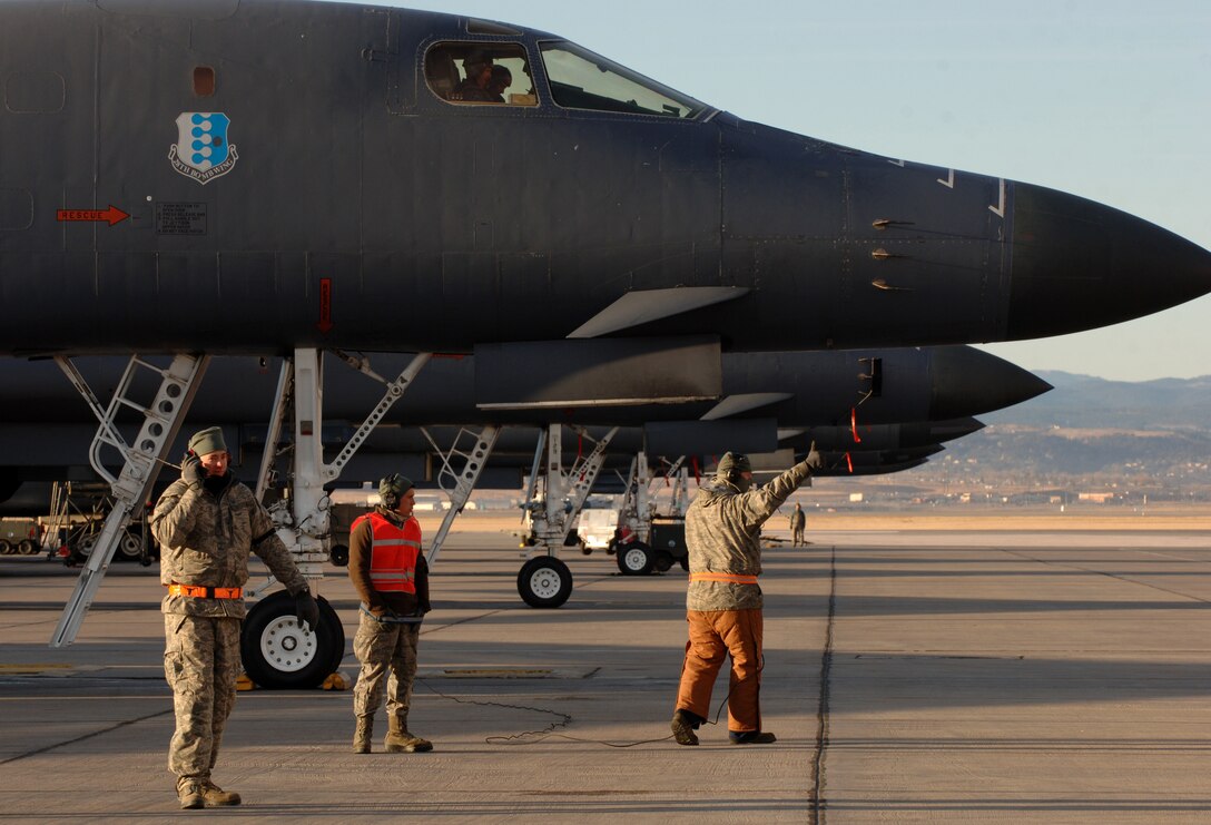 Maintainers from the 28th Aircraft Maintenance Squadron marshal B-1s for an aircraft surge on Ellsworth Air Force Base, S.D., Nov. 17, 2011. Ellsworth launched 20 sorties during the exercise that provided vital training and tested maintainers and aircrew combat readiness. (U.S. Air Force photo by Airman 1st Class Zachary Hada/Released)